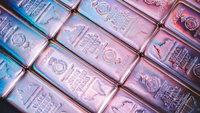 Silver's slide to the $58 area is being read as the end of the 2026 precious-metals story — and that reading gets the causality backwards. The metal fell more than 2% on July 8 after the US–Iran interim peace framework collapsed, extending a retreat from December's record above $83, yet the physical market underneath has tightened rather than loosened: Shanghai Futures Exchange warehouse inventories have collapsed 86% from their 2020 peak to 715 tonnes, the lowest since July 2016 (<a href="https://www.ebc.com/forex/silver-supply-deficit-explained-why-tight-inventories-could-still-squeeze-prices-in-2026">EBC Financial Group</a>, July 2026). Wall Street's targets frame the argument: Commerzbank sees $90 by year-end and Bank of America concedes a spike above $100 is possible, while the chart's bearish triangle points at $57.50 and the year-to-date low of $55.60 sits just below (<a href="https://www.fxleaders.com/news/2026/07/08/silver-price-forecast-bearish-triangle-breakdown-locks-target-near-57-50-as-post-treaty-carry-costs-intensify/">FX Leaders</a>, July 8, 2026). This silver price prediction maps the $90 bull case, the $55 bear case, and the single dispute that decides between them.
That dispute is not geopolitics — it is the most consequential forecasting disagreement in commodities right now, and almost no coverage puts the two numbers side by side. In April, the Silver Institute and Metals Focus projected the market's sixth consecutive structural deficit would *widen* 15% in 2026, to 46.3 million ounces from 40.3 million. Six weeks later, Bank of America's metals team argued the same deficit could *shrink by 90%* this year as solar manufacturers engineer silver out of their products. Both cannot be right, and every price target above — from $100 spikes to a $55 washout — is downstream of which deficit model you believe. Having tracked the metal across three rails this year (COMEX futures, London OTC and the always-open crypto-wrapped layer), the honest answer is that the physical inventories currently side with the Institute, while the substitution pipeline sides with BofA on a 2027 fuse.
<strong>Key Facts:</strong>
<blockquote>
• Silver trades near $58.40 after a 2%+ drop on July 8, down from a December 2025 record above $83 — <a href="https://tradingeconomics.com/commodity/silver">TradingEconomics</a>
• The Silver Institute and Metals Focus project a sixth consecutive deficit year, widening 15% to 46.3 million ounces in 2026 — Silver Institute annual outlook, April 15, 2026
• Bank of America counters that "the silver deficit could decline by 90% this year" on solar thrifting — Michael Widmer, BofA, May 29, 2026
• Shanghai Futures Exchange silver inventories have fallen 86% from the 2020 peak to 715 tonnes, a nine-year low — EBC Financial Group
• Bank targets span $60–65 (JPMorgan average), $68–74 (ING), ~$69 (BMO), $90 year-end (Commerzbank), with BofA allowing a $100+ spike — bank research, May–July 2026
• Technical picture: bearish triangle targeting $57.50, with the $55.60 year-to-date low as final support — FX Leaders, July 8, 2026
</blockquote>
What's actually happening: a haven unwind masking a supply story
Silver's 2026 round trip has been violent even by its own standards. The metal rode the Gulf conflict and the Fed-pivot trade to a record above $83 in December 2025, held $70 as recently as June 15, then gave up the entire war premium in eleven sessions when the US–Iran ceasefire landed — a move we tracked in real time in our <a href="https://financefeeds.com/silver-price-forecast-2026-year-end/">silver year-end forecast</a>. July's escalation reversed the politics but not the price: this week's collapse of the interim peace framework knocked silver lower still, because the metal's industrial half now outweighs its haven half whenever risk assets wobble.
The mechanism matters for what comes next. Roughly 70% of mine supply arrives as a byproduct of copper, zinc, lead and gold operations, which is why six years of deficits have produced so little supply response — byproduct miners do not add capacity because the silver credit improved. Demand, meanwhile, is dominated by industry (solar photovoltaics above all), which is exactly where the substitution battle is being fought. JPMorgan's Gregory Shearer, head of base and precious metals strategy, sees prices averaging $60–65 through the rest of the year and frames the real risk explicitly.
"Long term, the largest risk we see for silver comes from more widespread adoption of silver-free technology, such as the cadmium telluride thin-film technology. We've already seen some of the larger solar panel manufacturers in China announce thrifting plans... So we do think that this price rally has already set in motion an acceleration in substitution trends," Shearer said (<a href="https://finance.yahoo.com/news/silver-price-predictions-why-jpmorgan-123001668.html">Yahoo Finance</a>).
<strong>Quick Take:</strong> The war premium came and went; the deficit didn't. Silver at $58 is an industrial-substitution debate wearing a geopolitical costume.
The industry response: banks split, warehouses empty, refiners hedge
The institutional map has rarely been this polarised. Commerzbank holds the high ground at $90 by end-2026 and $95 by end-2027. ING ($68–74) and BMO (~$69) cluster in the middle. JPMorgan's $60–65 average is the working bear among the bulge bracket — and the substitution logic behind it is corroborated from the bullish side, since Bank of America's Michael Widmer makes the same observation with a harder number: "As silver prices rose almost exponentially, market participants such as solar PV manufacturers faced immense margin pressure, incentivizing efforts to engineer silver out of industrial products," he wrote, concluding that "the deficit in 2026 is expected to be so small that even modest investor sales would be enough to flip the market into a surplus" (<a href="https://finance.yahoo.com/markets/commodities/articles/bank-america-stark-message-silver-154038166.html">Yahoo Finance</a>, May 29, 2026).
Against that stands the physical evidence. SHFE warehouse stocks at 715 tonnes are not a forecast — they are what remains after two years of Chinese industrial drawdown, and COMEX registered coverage ratios near 13% tell the same story on the US side, a structural fragility we examined when <a href="https://financefeeds.com/silver-price-breaks-above-80-for-the-first-time-why-this-could-signal-a-bearish-turn/">silver first broke $80</a>. The market's plumbing — refiners quoting extended delivery times, lease rates spiking on borrow demand — behaves like the Institute's 46.3-million-ounce deficit, not like BofA's near-surplus. Someone's model is mis-specified, and the divergence itself is tradable information.
Market impact and the numbers: $90 bull vs $55 bear
The scenario map falls directly out of the deficit debate, with the technicals supplying the levels.
ScenarioTargetWhat has to happenKey evidence forKey evidence against
<strong>Bull — $90</strong>$90 by end-2026 (Commerzbank); BofA allows a $100+ spikeThe Institute's deficit model proves right; SHFE/COMEX inventory stress forces restocking; gold's Warsh-pivot bid spills overSix consecutive deficit years; SHFE stocks at nine-year lows; 70% byproduct supply can't respond to priceThrifting is already visible in Chinese solar bids; the haven bid now cuts against silver in risk-off weeks
<strong>Base — $65–74</strong>ING/BMO/JPM clusterDeficit narrows but doesn't flip; price grinds with gold's directionWidest bank cluster; matches JPM's $60–65 average with Q4 seasonalityRarely do polarised markets settle at consensus mid-points
<strong>Bear — $55</strong>$57.50 triangle target, then the $55.60 YTD lowBofA's 90% deficit collapse materialises; ETF and retail length liquidates into a surplus marketPost-treaty carry costs biting; bearish triangle already broken per FX Leaders; substitution acceleratingSpot inventories at multi-year lows make a true surplus hard to deliver into
<em>Sources: Commerzbank, BofA, ING, BMO, JPMorgan research (May–July 2026); Silver Institute/Metals Focus April 2026 outlook; FX Leaders technical analysis, July 8, 2026.</em>
The synthesis worth pricing: deficits are stocks-and-flows arguments, and the two sides are talking about different years. The Institute's 46.3-million-ounce 2026 shortfall is measured against demand already contracted; BofA's near-surplus is a statement about the *next* design cycle of solar panels, which takes 12–18 months to flow through fabrication lines. Both can be sequentially true — deficit now, surplus later — which is precisely the configuration that produced 2025's blow-off top and 2026's retracement. It also mirrors the pattern we flagged in our earlier <a href="https://financefeeds.com/silver-xag-price-prediction-2026-85-base-106-bull-55-bear/">silver $85 base / $106 bull / $55 bear scenario work</a>: the physical squeeze sets the highs, the substitution response sets the lows, and the price spends most of its time overshooting between them.
Two secondary reads support the sequencing thesis. First, positioning: the retail squeeze community that powered earlier episodes remains engaged — r/SilverSqueeze and r/Silverbugs are still among the most active commodity forums on Reddit this month — but engagement metrics are a fraction of the December mania, which means the speculative froth that needed flushing has largely been flushed. Second, the gold ratio: silver's underperformance since June has pushed the gold-silver ratio sharply higher at precisely the moment gold's central-bank bid (the Warsh-pivot trade) remains intact. Historically, ratio extremes during industrial-demand scares — 2016, 2020, 2024 — resolved with silver catching up violently rather than gold coming down, because the byproduct supply base cannot expand into the recovery. None of this tells you the week; all of it says the $55–58 zone is where the asymmetry lives, exactly as the December record made $80+ the zone where it died.
<strong>Quick Take:</strong> Deficit now, surplus later — both deficit models can be right in sequence. That's how you get $90 prints and $55 prints inside the same eighteen months.
The regulatory and market-structure tension
Silver's regulatory story in 2026 is about market structure rather than mandates. On COMEX, registered inventories covering roughly 13% of open interest keep the delivery mechanism under chronic scrutiny — the CFTC's position-limit framework was built for exactly this fragility, and every squeeze episode revives calls for tighter spot-month limits. In London, the LBMA's vault-transparency reporting has become the de facto disclosure regime for the OTC market that still clears most global volume. The newest layer is the one regulators have barely mapped: tokenised silver products trading around the clock on crypto rails, which we profiled in our <a href="https://financefeeds.com/xag-usd-outlook-silvers-uptrend-loses-momentum/">XAG/USD outlook</a> coverage of silver's three-rail market. The SEC's July "Regulation Crypto" agenda and the Treasury's stablecoin-issuer rules will eventually reach commodity-backed tokens, and when they do, the compliance perimeter around a 24/7 silver market becomes a genuine policy question — the push-pull between market access and delivery integrity that has defined silver regulation since the Hunt brothers.
What happens next: three predictions
<strong>First, the $55.60–57.50 zone holds on the first test.</strong> The causal chain: the bearish triangle's measured move and the YTD low coincide with the price band where Chinese industrial buyers restocked in both prior 2026 drawdowns, and SHFE inventories at nine-year lows leave little cushion for hesitation. A weekly close below $55.60 would invalidate this and open the JPMorgan-bear path toward the low $50s.
<strong>Second, the deficit debate resolves publicly at the Silver Institute's interim review in the autumn.</strong> If the 46.3-million-ounce projection survives contact with H1 solar fabrication data, the $90 Commerzbank path re-opens fast — thin inventories plus a confirmed deficit is the squeeze recipe. If the shortfall is revised toward BofA's near-zero, the bear case stops being a technical story and becomes a fundamental one.
<strong>Third, silver re-couples with gold by Q4.</strong> The gold-silver ratio blew out during the haven unwind because gold kept its central-bank bid while silver lost its industrial one. With the Fed's Warsh pivot still the macro base case and BofA explicitly tying a silver spike above $100 to "a rally in gold", the ratio trade — not the outright — is where institutional desks are already positioning. Watch ETF flows in both metals in the same week; the first synchronised inflow is the re-coupling signal.
FAQ
<strong>What is the silver price prediction for 2026?</strong>
Bank forecasts span JPMorgan's $60–65 average, ING's $68–74, BMO's ~$69 and Commerzbank's $90 year-end target, with Bank of America allowing a spike above $100 before reverting toward $75. Our scenario map for XAG/USD: $90 bull, $65–74 base, $55 bear from a roughly $58 spot price in early July.
<strong>Why is silver falling in 2026?</strong>
The haven premium unwound: silver held above $83 at December's record and near $71 in mid-June, then lost the war bid as the US–Iran ceasefire came and went. Substitution fears in solar manufacturing — engineering silver out of panels — have amplified the industrial-demand side of the selloff.
<strong>Is there really a silver supply deficit?</strong>
Disputed — and that dispute is the whole trade. The Silver Institute projects a sixth consecutive deficit, widening 15% to 46.3 million ounces in 2026; Bank of America argues thrifting could shrink the deficit by 90% and flip the market to surplus. Physical inventories (SHFE at nine-year lows) currently side with the deficit camp.
<strong>Will silver reach $100?</strong>
Bank of America itself concedes a gold-led rally "could once again boost silver above $100/oz in the coming months", and Commerzbank's $90 year-end path points the same direction. A sustained $100+ requires the deficit model to win the data fight and inventories to stay stressed through Q4.
<strong>What is the bear case for silver?</strong>
A deficit that evaporates. If solar thrifting cuts industrial offtake as fast as BofA models, even modest investor selling flips the market to surplus; technically, the broken triangle targets $57.50 with the $55.60 year-to-date low as the last support before the low $50s.
<strong>How can I trade silver?</strong>
Via spot XAG/USD with FX and CFD brokers, COMEX futures and options, physically backed ETFs, silver miners, and — increasingly — tokenised silver products that trade around the clock on crypto rails. Each rail carries different counterparty, delivery and regulatory characteristics; retail leverage on silver CFDs is capped at 10:1 in most regulated jurisdictions, and leveraged products carry total-loss risk.
<em>This article is informational analysis only and is not financial or investment advice. Commodities and leveraged products are volatile and can lose substantial value rapidly. Do your own research and consult a regulated financial adviser before making any investment decision.</em>